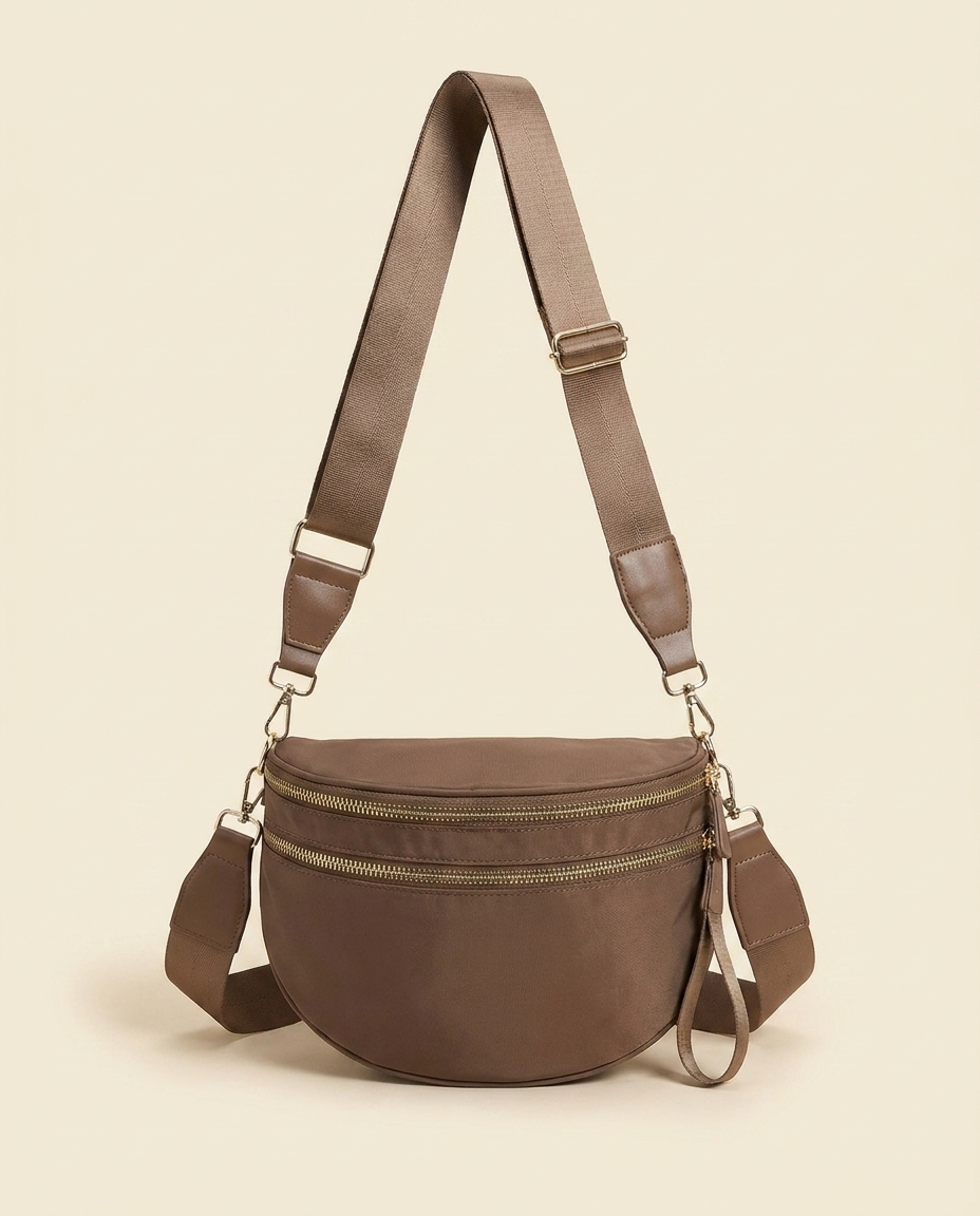 The Crescent Shoulder Bag in Taupe — front view with adjustable webbing strap