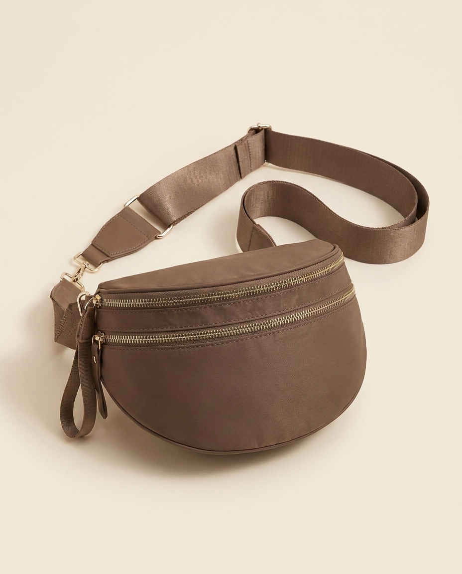 The Crescent Shoulder Bag in Taupe — three-quarter angle view