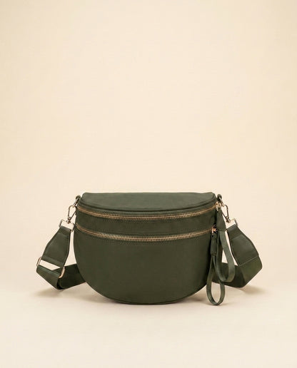The Crescent Shoulder Bag in Forest — dark green nylon crossbody with gold-tone double zippers