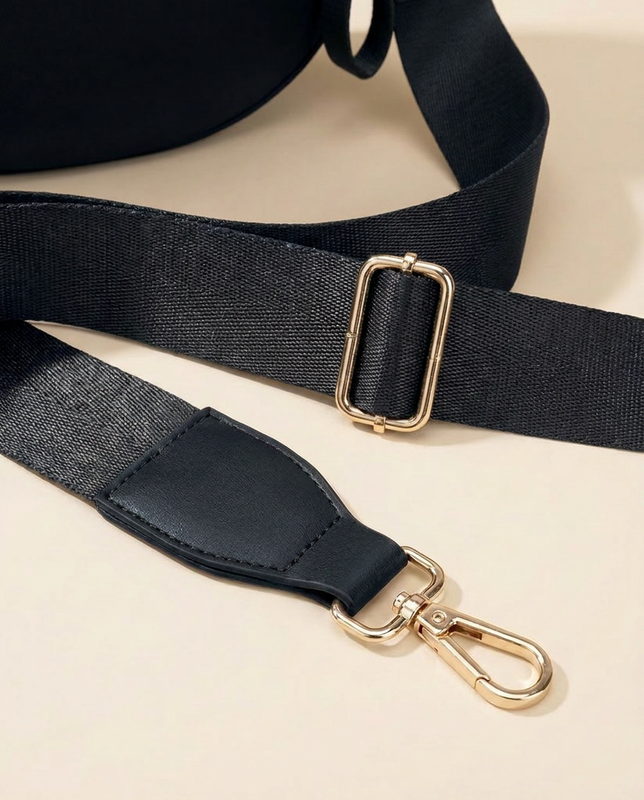The Crescent Shoulder Bag in Ink — detail of adjustable strap with gold-tone hardware