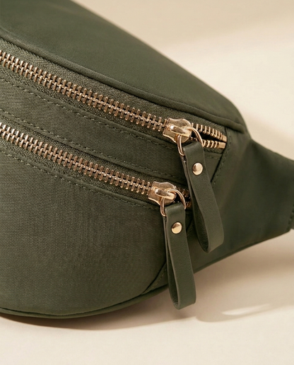 The Crescent Shoulder Bag in Forest — detail of double gold-tone zippers