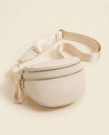 The Crescent Shoulder Bag in Sand — three-quarter angle view