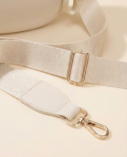 The Crescent Shoulder Bag in Sand — detail of adjustable strap with gold-tone hardware