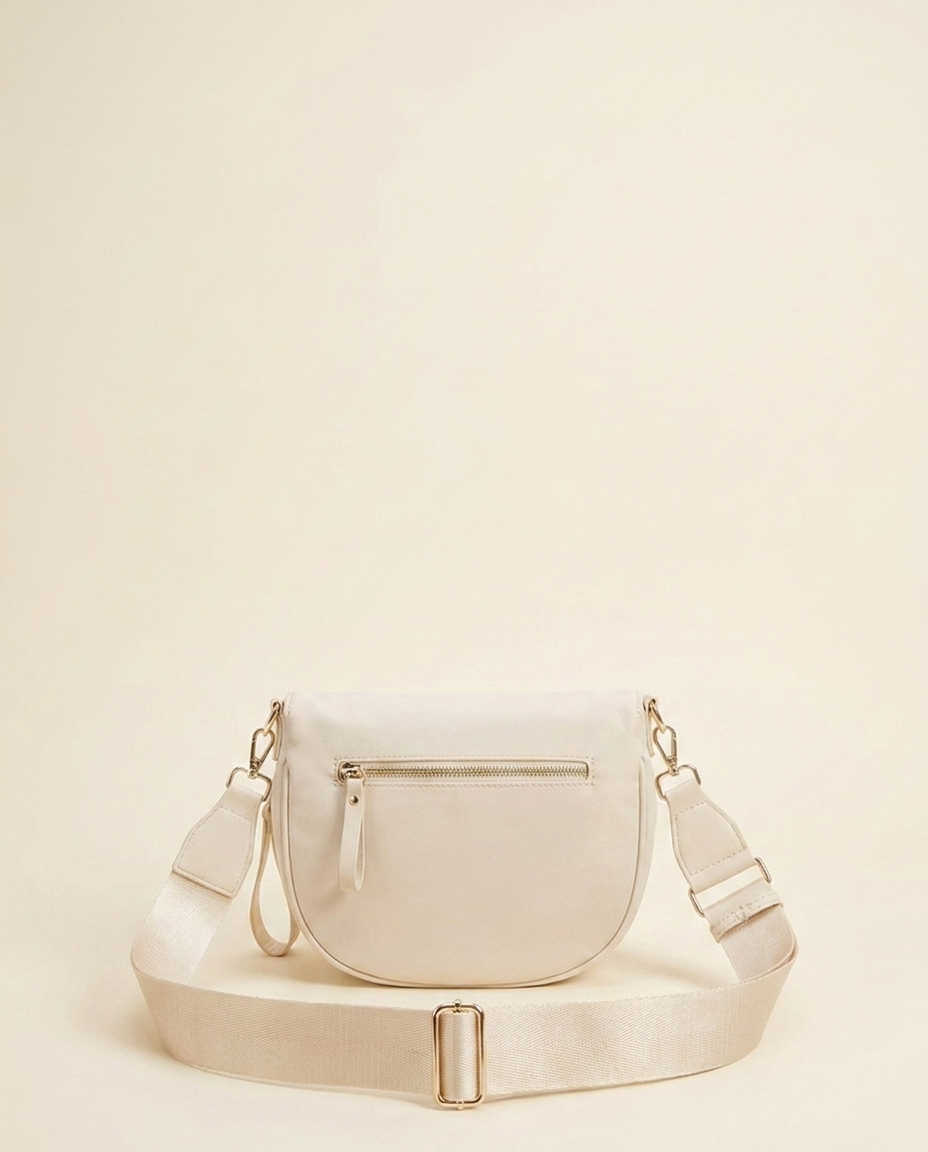 The Crescent Shoulder Bag in Sand — back view with hidden zip pocket