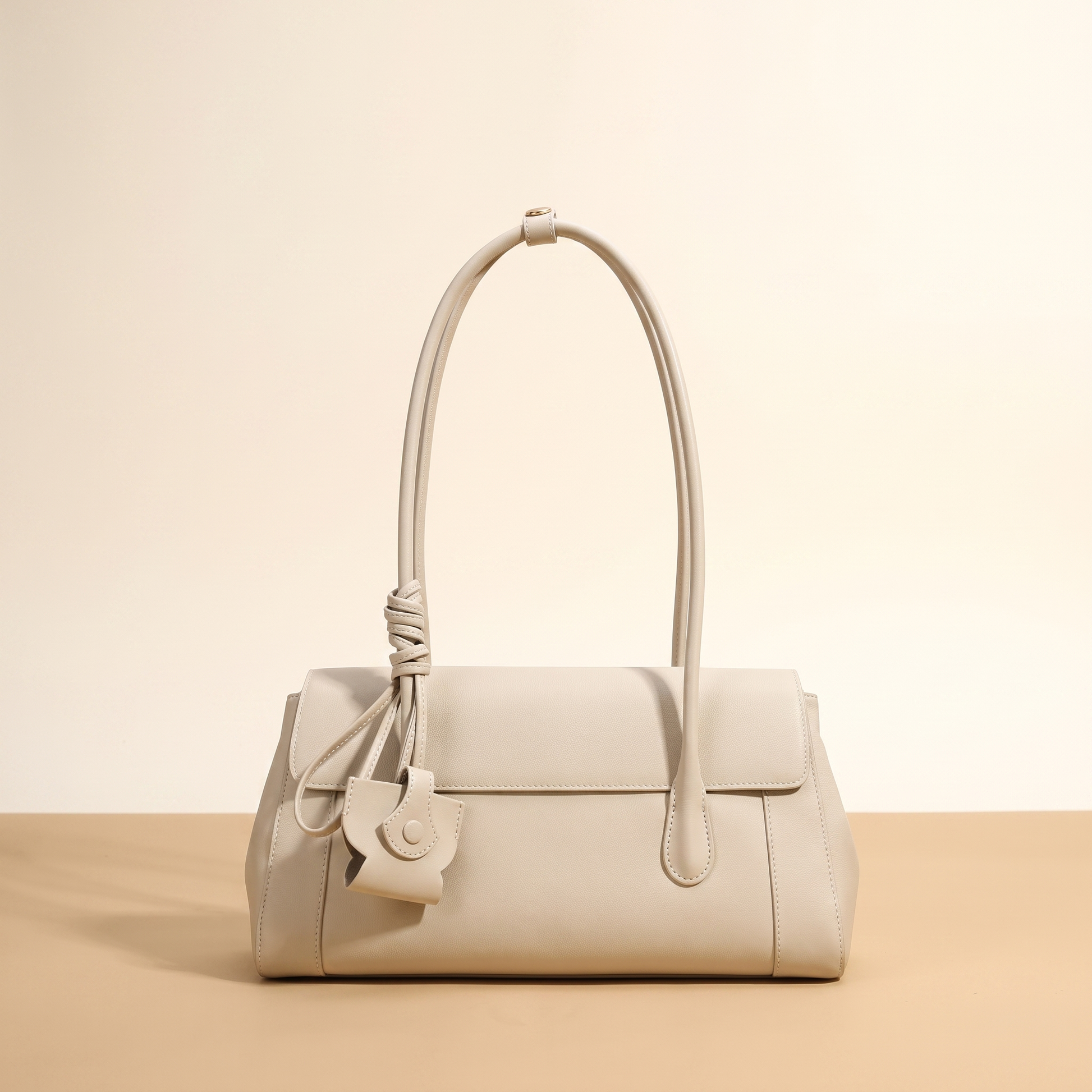 Colette leather shoulder bag in Ivory shown against a neutral backdrop