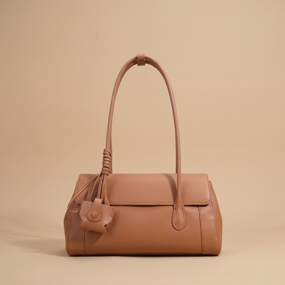 Colette Structured Leather Shoulder Bag in Cognac on a warm sand studio backdrop