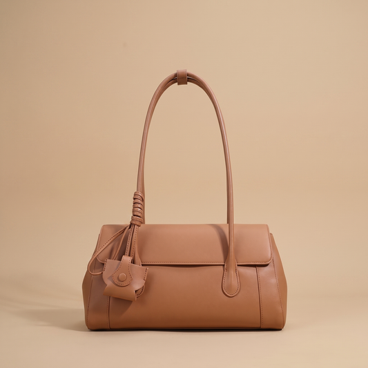 Colette Structured Leather Shoulder Bag in Cognac on a warm sand studio backdrop
