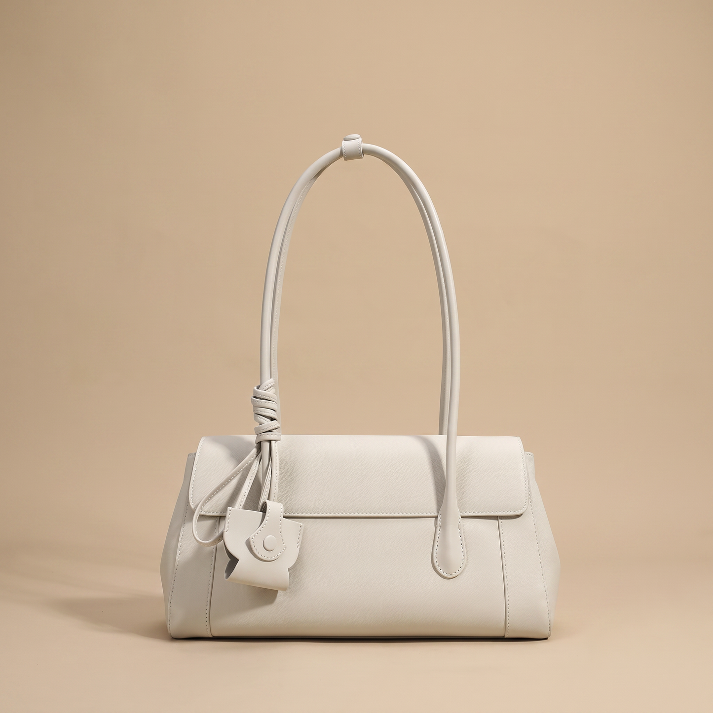 Colette Structured Leather Shoulder Bag in Ivory on a warm sand studio backdrop