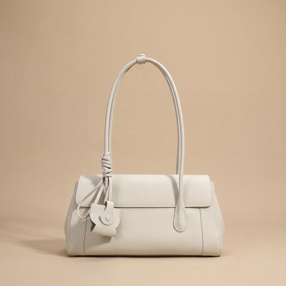 Colette Structured Leather Shoulder Bag in Ivory on a warm sand studio backdrop