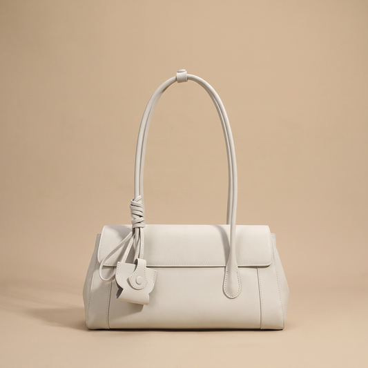 Colette Structured Leather Shoulder Bag in Ivory on a warm sand studio backdrop