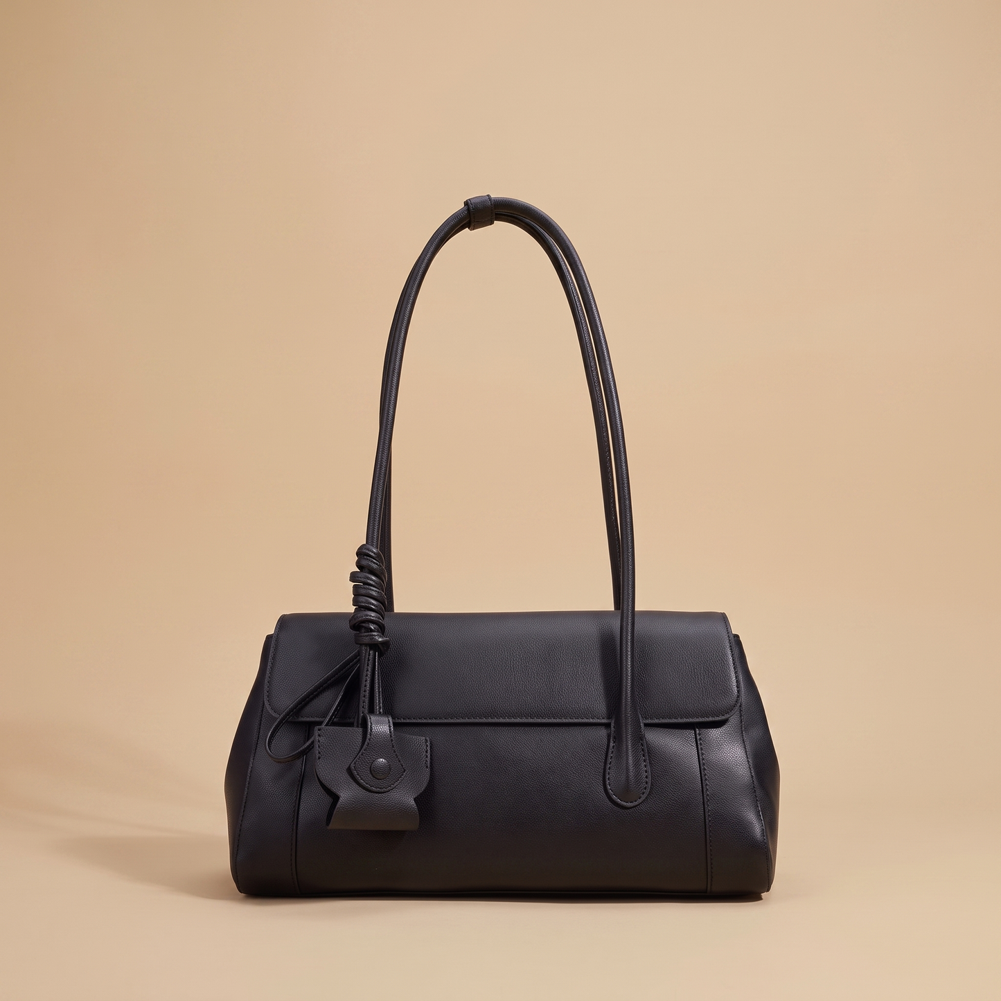 Colette Structured Leather Shoulder Bag in Ink on a warm sand studio backdrop