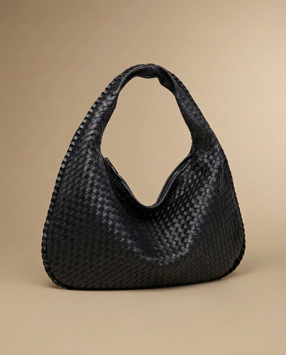 Séverine Woven Tote by Aurevy, three-quarter angle on a warm sand studio backdrop