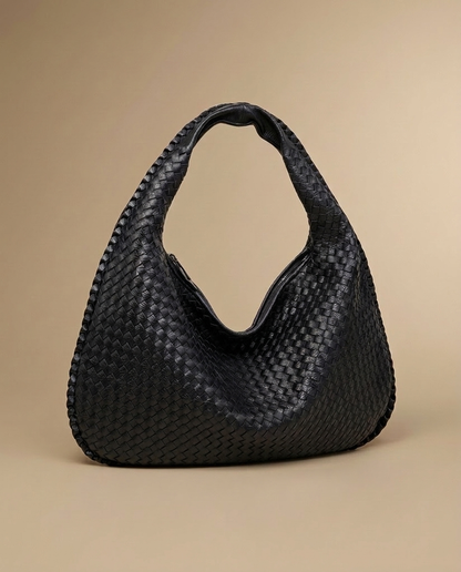 Séverine Woven Tote by Aurevy, three-quarter angle on a warm sand studio backdrop