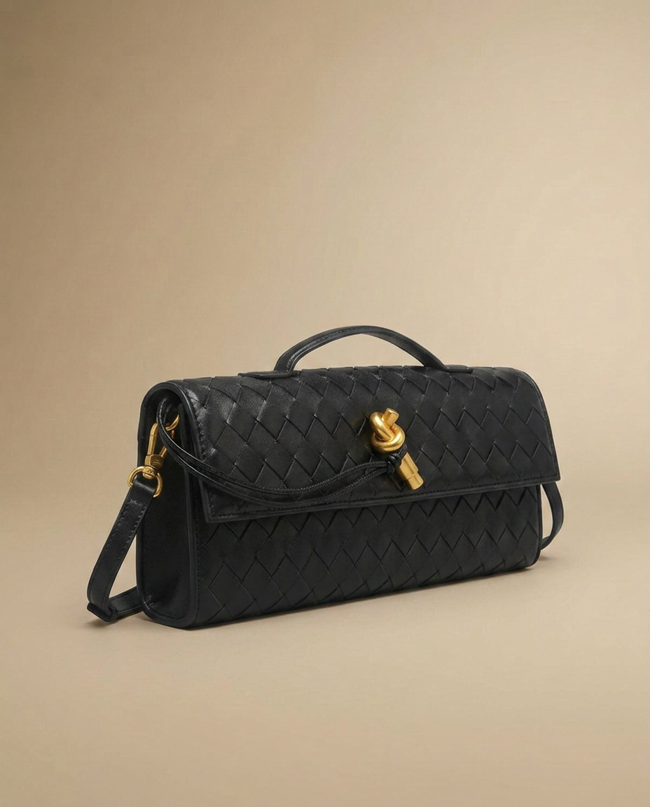 Adèle Woven Clutch by Aurevy, three-quarter angle on a warm sand studio backdrop